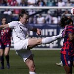 
              New Zealand defender Meikayla Moore, left, kicks the ball past United States midfielder Catarina Macario during the first half of the 2022 SheBelieves Cup soccer match Sunday, Feb. 20, 2022, in Carson, Calif. (AP Photo/Mark J. Terrill)
            