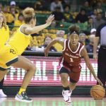 
              Oklahoma guard Nevaeh Tot, right, drives past Baylor guard Jaden Owens during the first half of an NCAA college basketball game Wednesday, Feb. 2, 2022, in Waco, Texas. (Rod Aydelotte/Waco Tribune-Herald via AP)
            
