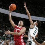 
              Wisconsin's Johnny Davis, left, shoots against Michigan State's Max Christie (5) during the first half of an NCAA college basketball game, Tuesday, Feb. 8, 2022, in East Lansing, Mich. (AP Photo/Al Goldis)
            
