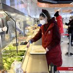 
              FILE - An athlete orders food at a restaurant at the Olympic Village ahead of the 2022 Winter Olympics, Feb. 1, 2022, in Beijing. (Wang Zhao/Pool Photo via AP, File)
            