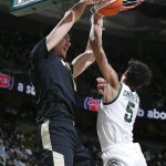 
              Purdue's Zach Edey, left, dunks against Michigan State's Max Christie (5) during the first half of an NCAA college basketball game, Saturday, Feb. 26, 2022, in East Lansing, Mich. (AP Photo/Al Goldis)
            