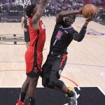 
              Los Angeles Clippers guard Reggie Jackson, right, shoots as Houston Rockets forward Jae'Sean Tate defends during the first half of an NBA basketball game Thursday, Feb. 17, 2022, in Los Angeles. (AP Photo/Mark J. Terrill)
            