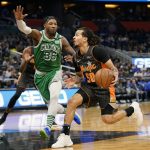 
              Orlando Magic guard Cole Anthony (50) drives to the basket against Boston Celtics guard Marcus Smart (36) during the first half of an NBA basketball game, Sunday, Feb. 6, 2022, in Orlando, Fla. (AP Photo/John Raoux)
            