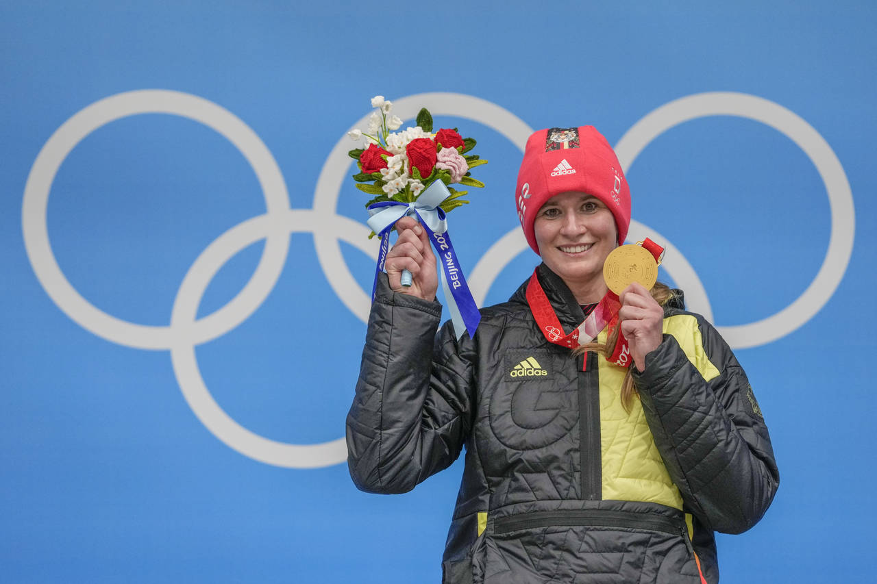Natalie Geisenberger, of Germany, shows the gold medal at the podium for the luge women's singles a...