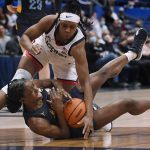 
              Connecticut's Christyn Williams, top pressures Marquette's Antwainette Walker during the first half of an NCAA college basketball game Wednesday, Feb. 23, 2022, in Hartford, Conn. (AP Photo/Jessica Hill)
            