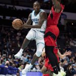 
              Charlotte Hornets guard Terry Rozier (3) drives to the basket while guarded by Toronto Raptors forward Precious Achiuwa (5) during the first half of an NBA basketball game in Charlotte, N.C., Monday, Feb. 7, 2022. (AP Photo/Jacob Kupferman)
            