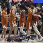 
              Texas players celebrate after a win against West Virginia during the second half of an NCAA college basketball game in Morgantown, W.Va., Saturday, Feb. 26, 2022. (AP Photo/Kathleen Batten)
            