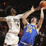 
              Oregon State forward Ahmad Rand, left, tries to block a shot by UCLA forward Jaime Jaquez Jr., right, during the second half of an NCAA college basketball game on Saturday, Feb. 26, 2022, in Corvallis, Ore. UCLA won 94-55. (AP Photo/Amanda Loman)
            
