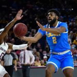 
              UCLA forward Cody Riley (2) is defended by Arizona State guard DJ Horne (0) during the first half of an NCAA college basketball game Saturday, Feb. 5, 2022, in Tempe, Ariz. (AP Photo/Ross D. Franklin)
            