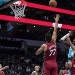 
              Charlotte Hornets center Montrezl Harrell (8) shoots over Miami Heat guard Gabe Vincent (2) and center Omer Yurtseven (77) during the first half of an NBA basketball game Thursday, Feb. 17, 2022, in Charlotte, N.C. (AP Photo/Matt Kelley)
            