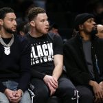 
              Brooklyn Nets' Ben Simmons, Blake Griffin and Kevin Durant watch teammates play against the Boston Celtics during the first half of an NBA basketball game Thursday, Feb. 24, 2022, in New York. (AP Photo/Noah K. Murray)
            