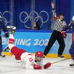 
              Russian Olympic Committee's Nina Pirogova (13) falls in front of United States' Jesse Compher (18) during a preliminary round women's hockey game at the 2022 Winter Olympics, Saturday, Feb. 5, 2022, in Beijing. (AP Photo/Petr David Josek)
            