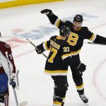 
              Boston Bruins' Patrice Bergeron is congratulated by Taylor Hall after Bergeron scored on Colorado Avalanche goaltender Darcy Kuemper during the second period of an NHL hockey game Monday, Feb. 21, 2022, in Boston. (AP Photo/Winslow Townson)
            