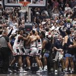 
              Connecticut players celebrate after regaining possession of the ball in the final second of the team's NCAA college basketball game against Villanova, Tuesday, Feb. 22, 2022, in Hartford, Conn. (AP Photo/Jessica Hill)
            