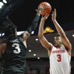 
              Houston guard Ramon Walker Jr. (3) shoots for three points against Central Florida forward Isaiah Adams (3) during the second half of an NCAA college basketball game Thursday, Feb. 17, 2022, in Houston. (AP Photo/Justin Rex)
            