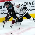 
              Los Angeles Kings defenseman Matt Roy (3) and Arizona Coyotes right wing Clayton Keller (9) compete for the puck during the first period of an NHL hockey game Wednesday, Feb. 23, 2022, in Glendale, Ariz. (AP Photo/Ross D. Franklin)
            
