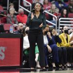 
              Notre Dame head coach Niele Ivey tries to get her team's attention during the second half of an NCAA college basketball game against Louisville in Louisville, Ky., Sunday, Feb. 13, 2022. (AP Photo/Timothy D. Easley)
            
