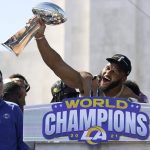 
              Los Angeles Rams defensive lineman Aaron Donald holds up the Vince Lombardi Super Bowl trophy during the team's victory celebration and parade in Los Angeles, Wednesday, Feb. 16, 2022, following the Rams' win Sunday over the Cincinnati Bengals in the NFL Super Bowl 56 football game. (AP Photo/Marcio Jose Sanchez)
            