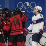 
              Canada's Marie-Philip Poulin (29) celebrates a goal with teammates during the women's gold medal hockey game as United States' Megan Keller (5) skates by at the 2022 Winter Olympics, Thursday, Feb. 17, 2022, in Beijing. (AP Photo/Petr David Josek)
            