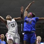
              Connecticut's Christyn Williams (13) shoots over DePaul's Aneesah Morrow (24) in the first half of an NCAA college basketball game, Friday, Feb. 11, 2022, in Storrs, Conn. (AP Photo/Jessica Hill)
            