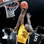 Arizona State forward Alonzo Gaffney (32) tries to shoot the ball as Washington State forward Efe Abogidi (0) blocks his shot and Washington State guard T.J. Bamba (5) defends during the first half of an NCAA college basketball game Saturday, Feb. 12, 2022, in Pullman, Wash. (AP Photo/August Frank)