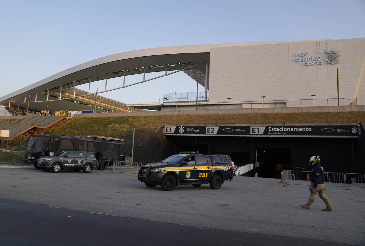 FILE - Police stand guard outside Neo Quimica Arena stadium after a qualifying soccer match between...