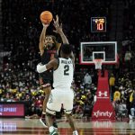 
              Maryland guard Fatts Russell (4) shoots a three-point basket against Michigan State guard Tyson Walker (2) during the second half of an NCAA college basketball game, Tuesday, Feb. 1, 2022, in College Park, Md. Michigan State won 65-63. (AP Photo/Julio Cortez)
            