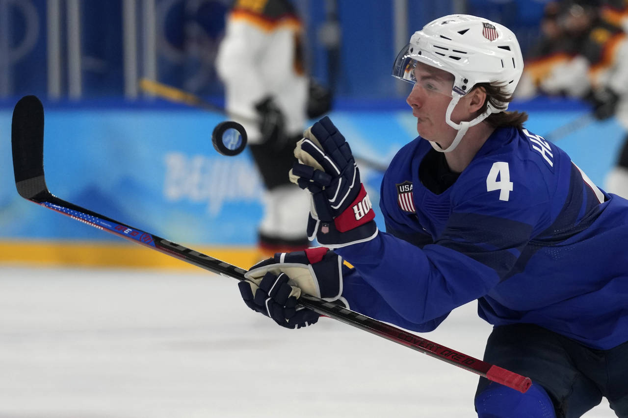 United States' Drew Helleson (4) reaches for the puck during a preliminary round men's hockey game ...