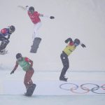
              Kristina Paul, of the Russian Olympic Committee, right, leads the pack, followed by Canada's Meryeta O'Dine, United States Faye Gulini and France's Chloe Trespeuch, during the mixed team snowboard cross finals at the 2022 Winter Olympics, Saturday, Feb. 12, 2022, in Zhangjiakou, China. (AP Photo/Gregory Bull)
            