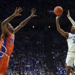 
              Kentucky's Tyty Washington Jr. (3) shoots while defended by Florida's Phlandrous Fleming (24) during the second half of an NCAA college basketball game in Lexington, Ky., Saturday, Feb. 12, 2022. (AP Photo/James Crisp)
            