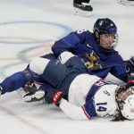
              United States' Brianna Decker (14) lies on the ice after colliding with Finland's Ronja Savolainen (88) during a preliminary round women's hockey game at the 2022 Winter Olympics, Thursday, Feb. 3, 2022, in Beijing. (AP Photo/Petr David Josek)
            