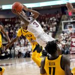 
              Texas A&M guard Quenton Jackson (3) gets a shot off after being fouled by Missouri forward Yaya Keita (11) during the second half of an NCAA college basketball game, Saturday, Feb. 5, 2022, in College Station, Texas. (AP Photo/Sam Craft)
            