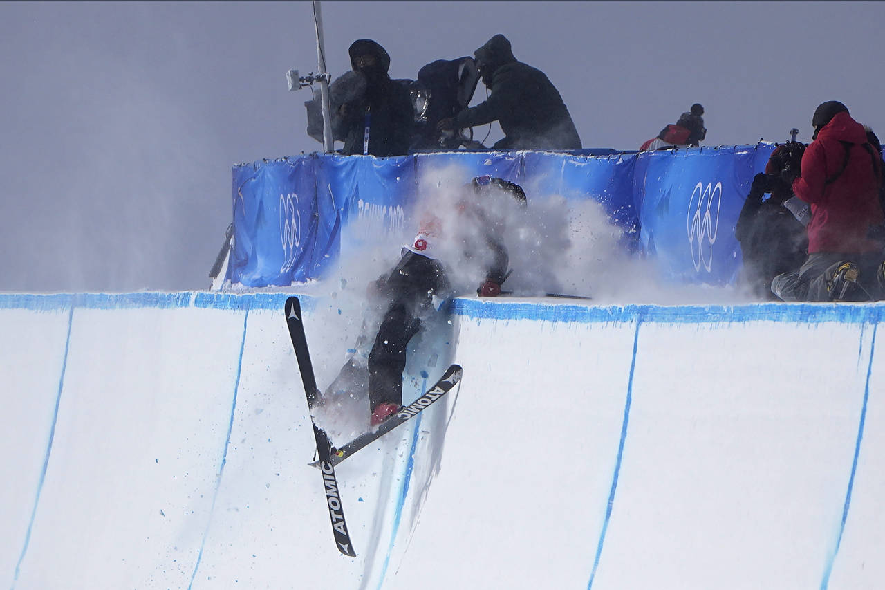 Britain's Gus Kenworthy crashes during the men's halfpipe finals at the 2022 Winter Olympics, Satur...
