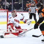 
              Carolina Hurricanes goaltender Frederik Andersen, left, looks for the puck after making a save as Philadelphia Flyers' James van Riemsdyk (25) moves in during the second period of an NHL hockey game, Monday, Feb. 21, 2022, in Philadelphia. (AP Photo/Derik Hamilton)
            