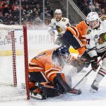 
              Chicago Blackhawks' Kirby Dach (77) is stopped by Edmonton Oilers goalie Mike Smith (41) during the first period of an NHL hockey game Wednesday, Feb. 9, 2022, in Edmonton, Alberta. (Jason Franson/The Canadian Press via AP)
            