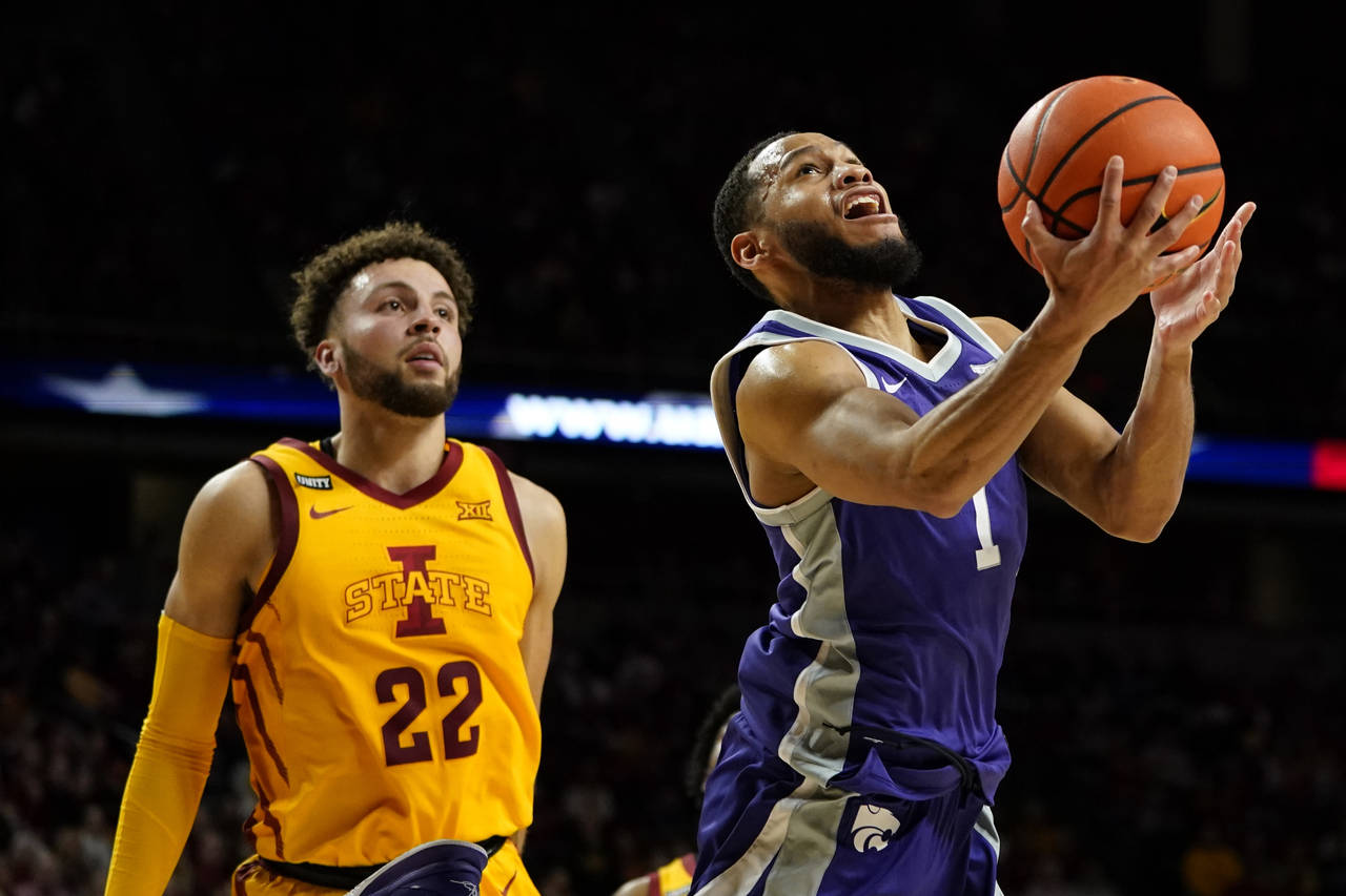 Kansas State guard Markquis Nowell (1) drives to the basket ahead of Iowa State guard Gabe Kalscheu...