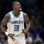 
              Charlotte Hornets guard Terry Rozier reacts after making a 3-pointer against the Toronto Raptors during the second half of an NBA basketball game in Charlotte, N.C., Monday, Feb. 7, 2022. (AP Photo/Jacob Kupferman)
            