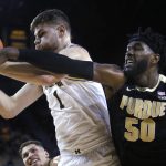 
              Michigan center Hunter Dickinson (1) beats Purdue forward Trevion Williams (50) to a rebound during the first half of an NCAA college basketball game Thursday, Feb. 10, 2022, in Ann Arbor, Mich. (AP Photo/Duane Burleson)
            