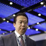 
              FILE - Interpol President, Meng Hongwei, walks toward the stage to deliver his opening address at the Interpol World Congress in Singapore,  July 4, 2017. (AP Photo/Wong Maye-E, File)
            
