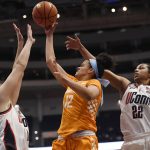 
              Tennessee's Rae Burrell (12) shoots between Connecticut's Dorka Juhász and Connecticut's Evina Westbrook (22) in the first half of an NCAA college basketball game, Sunday, Feb. 6, 2022, in Hartford, Conn. (AP Photo/Jessica Hill)
            