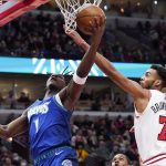 
              Minnesota Timberwolves forward Anthony Edwards, left, shoots against Chicago Bulls forward Troy Brown Jr. during the first half of an NBA basketball game in Chicago, Friday, Feb. 11, 2022. (AP Photo/Nam Y. Huh)
            