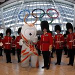
              FILE - The London 2012 Olympic mascot Wenlock poses with the Band of Irish Guards under Olympic rings unveiled at Heathrow airport Terminal 5 ready to welcome visitors to the London 2012 Olympic Games, June 20, 2012. (AP Photo/Sang Tan, File)
            