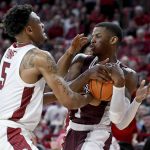 
              Mississippi State guard Iverson Molinar (1) and Arkansas guard Au'Diese Toney (5) vie for control of a rebound during the second half of an NCAA college basketball game Saturday, Feb. 5, 2022, in Fayetteville, Ark. (AP Photo/Michael Woods)
            