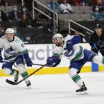 
              Vancouver Canucks defenseman Kyle Burroughs, front right, scores against San Jose Sharks during the second period of an NHL hockey game in San Jose, Calif., Thursday, Feb. 17, 2022. (AP Photo/Josie Lepe)
            