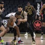 
              Denver Nuggets' Bones Hyland, second from left, battles for the ball with Toronto Raptors' Gary Trent Jr., left, and Fred VanVleet during the first half of an NBA basketball game, Saturday, Feb. 12, 2022 in Toronto. (Chris Young/The Canadian Press via AP)
            