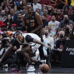 
              Miami Heat center Bam Adebayo (13) and Brooklyn Nets forward James Johnson battle for a loose ball during the second half of an NBA basketball game, Saturday, Feb. 12, 2022, in Miami. (AP Photo/Wilfredo Lee)
            