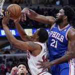 
              Philadelphia 76ers center Joel Embiid, right, blocks a shot by Chicago Bulls forward Malcolm Hill during the second half of an NBA basketball game in Chicago, Sunday, Feb. 6, 2022. (AP Photo/Nam Y. Huh)
            