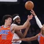 
              New York Knicks' Mitchell Robinson, center, battles Oklahoma City Thunder's Isaiah Roby (22) and Aaron Wiggins, right, during the first half of an NBA basketball game Monday, Feb. 14, 2022, in New York. (AP Photo/John Munson)
            