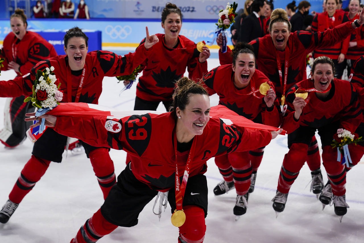 Canada's Marie-Philip Poulin (29) celebrates with her gold medal after the women's gold medal hocke...