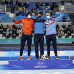 
              Gold medalist Nils van der Poel of Sweden, center, celebrates with silver medalist Patrick Roest of the Netherlands, left, and bronze medalist Hallgeir Engebraaten of Norway after the men's speedskating 5,000-meter race at the 2022 Winter Olympics, Sunday, Feb. 6, 2022, in Beijing. (AP Photo/Ashley Landis)
            
